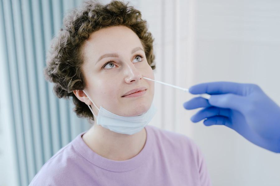 A patient receives a quick nasal swab test