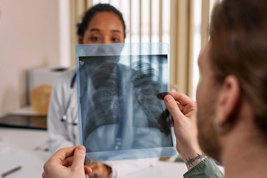 A doctor reviews a chest X-ray with a patient